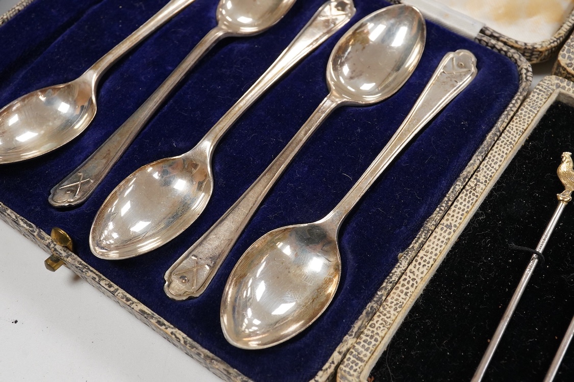A collection of assorted silver to include five napkin rings including two pairs, a cased pair of glass butter dishes with silver butter knives, five golf related teaspoons, a cased set of six sterling cocktail sticks wi